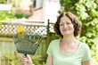 Photo: Senior woman holding rake Senior woman holding rake