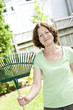 Photo: Senior woman holding rake Senior woman holding rake