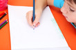 Photo: Child drawing in his notebook Child drawing in his notebook