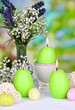 Photo: Easter candles with flowers on bright background Easter candles with flowers on bright background