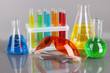 Test-tubes with colorful liquids on gray background