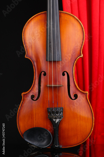 Photo: Classical violin on curtain background Classical violin on curtain background