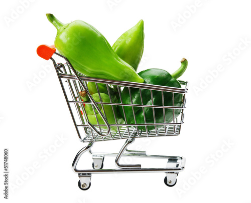 Photo: Green sweet pepper paprika in shopping trolley isolated on whit Green sweet pepper paprika in shopping trolley isolated on whit