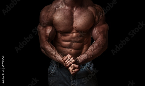 Photo: Bodybuilder isolated on black background Bodybuilder isolated on black background