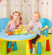 Two children paint Easter eggs
