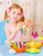 Photo: Baby girl painting Easter eggs Baby girl painting Easter eggs