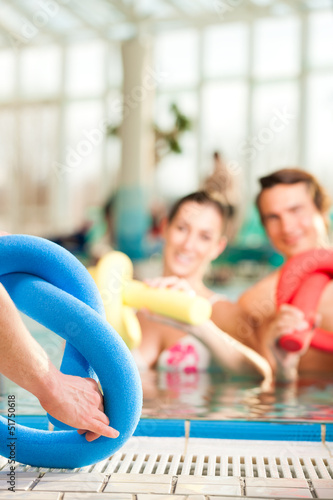 Photo: Fitness - sports gymnastics under water in swimming pool Fitness - sports gymnastics under water in swimming pool