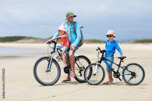 Photo: Father and kids riding bikes Father and kids riding bikes