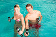 Fitness - gymnastics under water in swimming pool