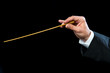 Conductors hand with baton.
