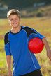 Cute boy with soccer ball outdoors.