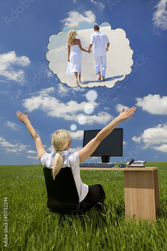 Photo: Businesswoman Daydreaming at Desk in Green Field Businesswoman Daydreaming at Desk in Green Field