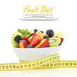 Diet meal. Fruit salad in a bowl with measuring tape