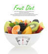Diet meal. Fruit salad in a bowl with weight scale