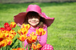 beautiful little girl with tulip flowers portrait