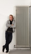 portrait of young man, leaning on the radiator