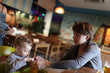Mother gives to drink her toddler juice