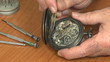 Watchmaker examines pocket watch