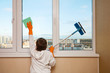 A boy washes a window