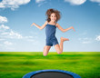 cheerful girl jumping on a meadow