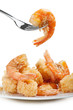 plate of fried fish on white background with fork
