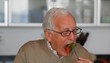 Close up of senior Caucasian man eating vegetables
