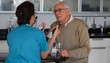 Caucasian nurse checking blood pressure of senior man
