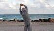 Senior Caucasian man stretching at the beach