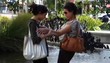 Two women meeting on city street