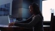 Black woman using laptop at table