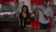 Couple at dinner table in upscale home lighting candles and pouring wine  