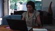 Black woman at home working on laptop
