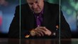 Hispanic man at table watching goldfish swim