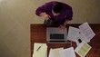 Hispanic man at table working on laptop