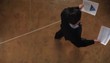 Hispanic businessman pacing floor while on telephone