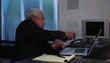 Senior businessman talking on phone and making notes