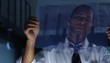 Businessman analyzing transparency graph in office