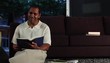 Mature man at home in evening reading a book
