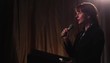 Video: Businesswoman at lectern holding microphone, addressing audience and using cell phone Businesswoman at lectern holding microphone, addressing audience and using cell phone
