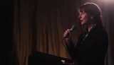 Video: Businesswoman at lectern holding microphone, addressing audience and using cell phone Businesswoman at lectern holding microphone, addressing audience and using cell phone