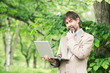 Portrait of happy middle-aged businessman holding notebook and s