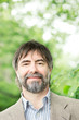 Portrait of happy middle-aged businessman looking at camera and