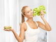 Photo: woman with green lettuce and hamburger woman with green lettuce and hamburger