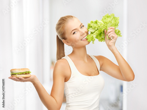Photo: woman with green lettuce and hamburger woman with green lettuce and hamburger