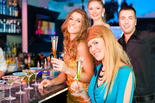 Photo: People in club or bar drinking champagne People in club or bar drinking champagne