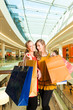 Foto: Two women shopping with bags in mall Two women shopping with bags in mall