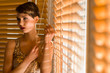 Woman and venetian blind