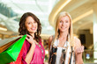 Foto: Two women shopping with bags in mall Two women shopping with bags in mall