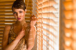 Photo: Woman and venetian blind Woman and venetian blind