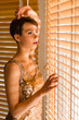 Photo: Woman and venetian blind Woman and venetian blind